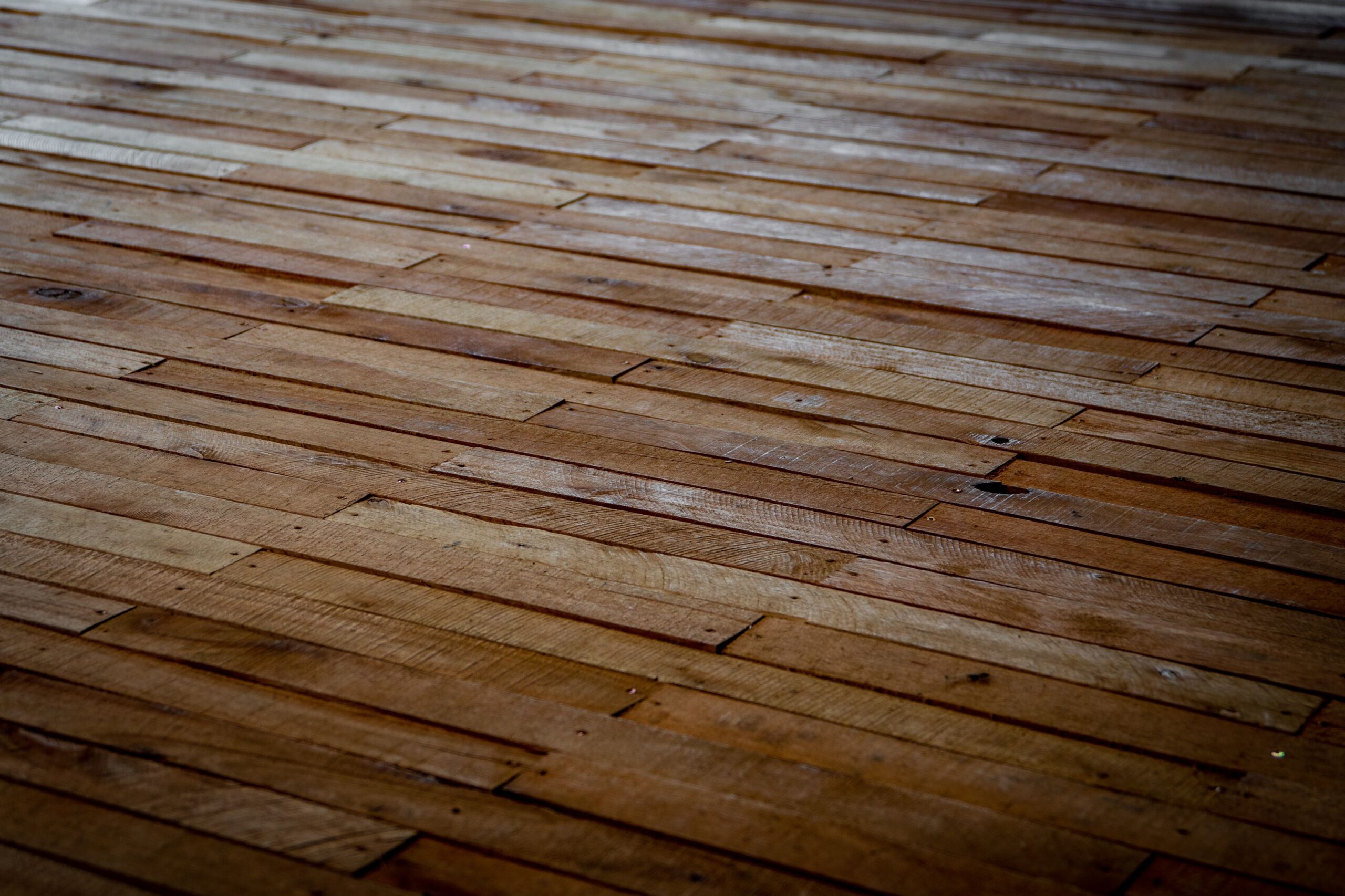 Freshly installed luxury vinyl plank flooring with staggered wood-grain boards.