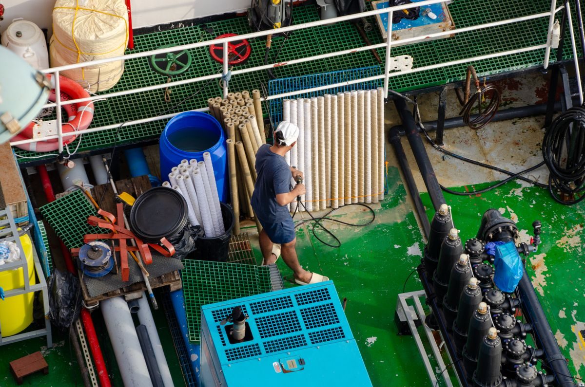 Pool technician servicing pump and filter equipment