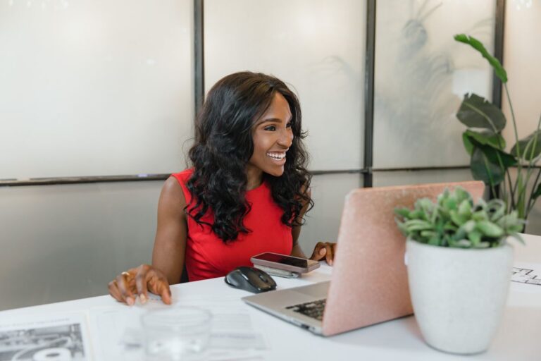 A small business owner working on her laptop, researching SEO strategy for her local service business