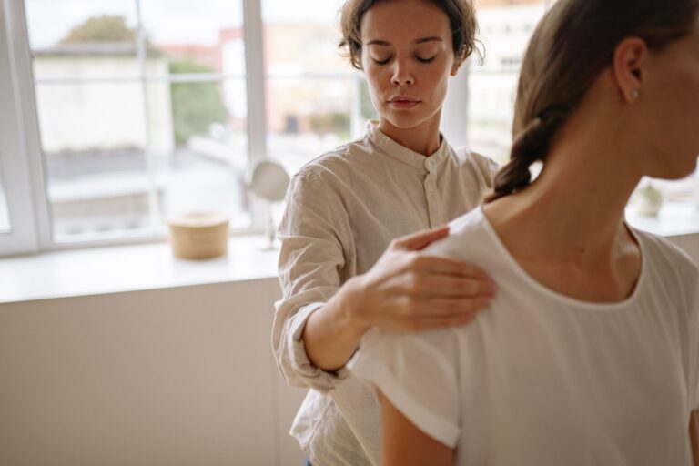 Physical therapist treating a patient in a bright rehabilitation clinic