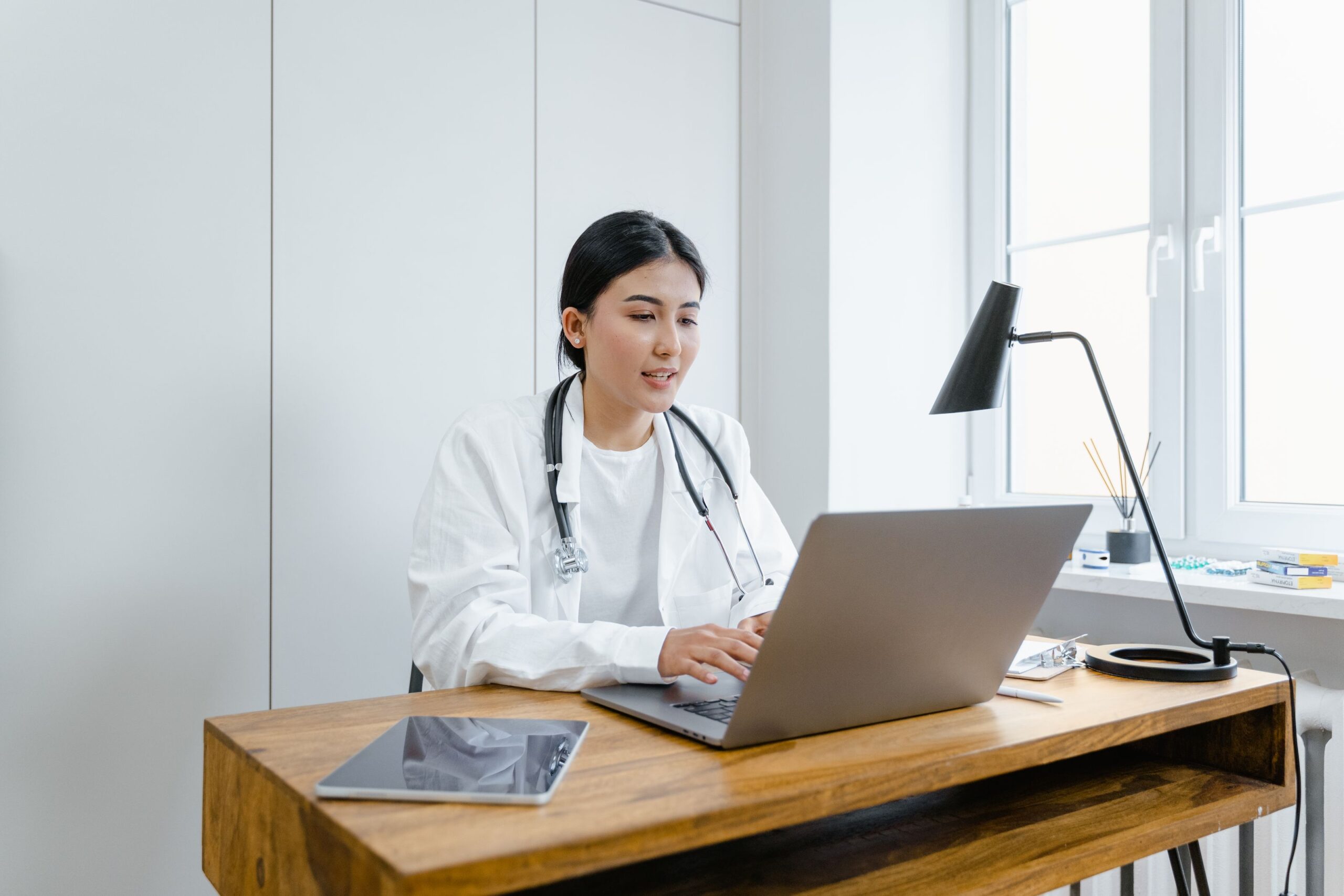 Healthcare professional reviewing website performance on a laptop