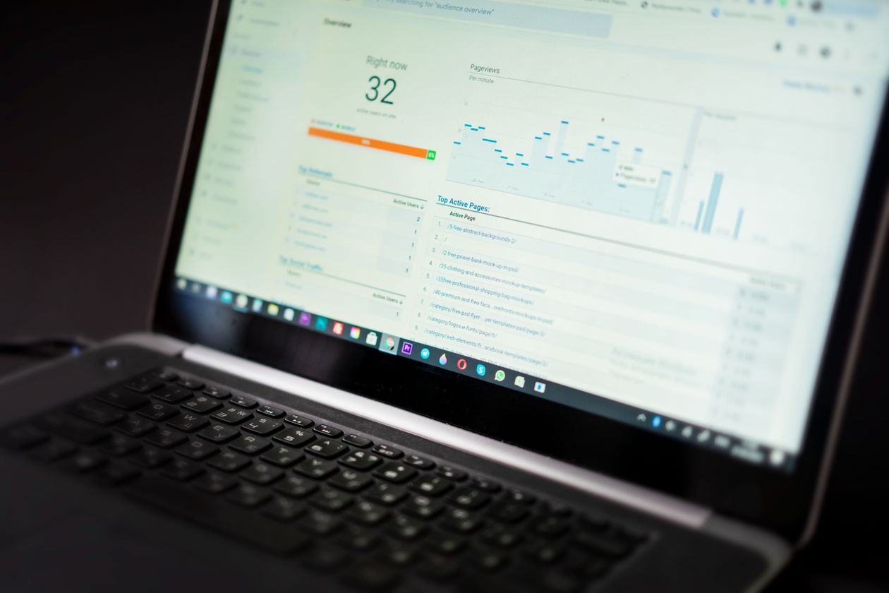 Laptop screen showing website analytics dashboard with traffic growth data