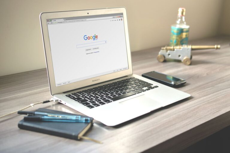 Laptop displaying Google search results on a wooden desk for local SEO