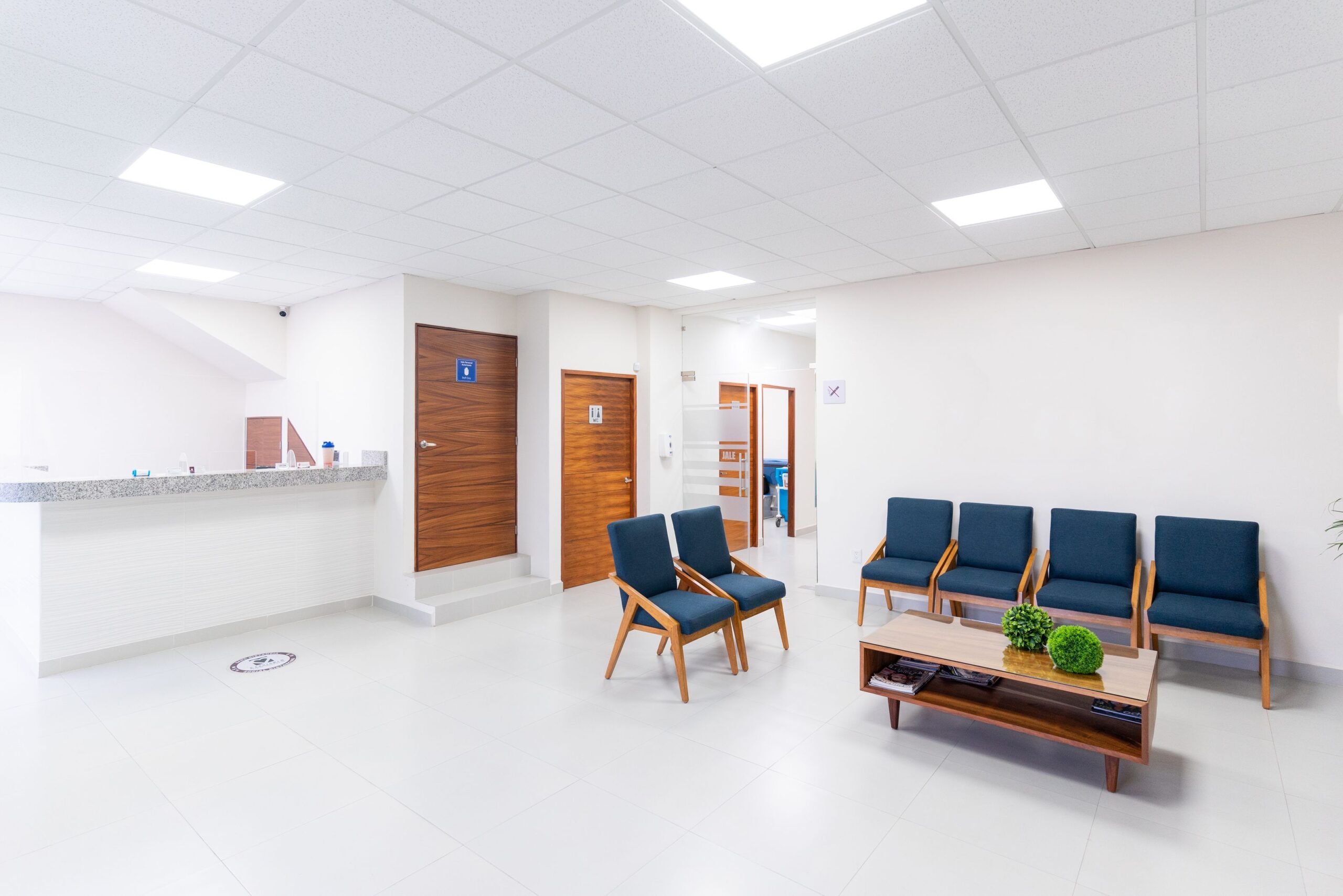 Bright, clean plastic surgery clinic waiting room with reception counter
