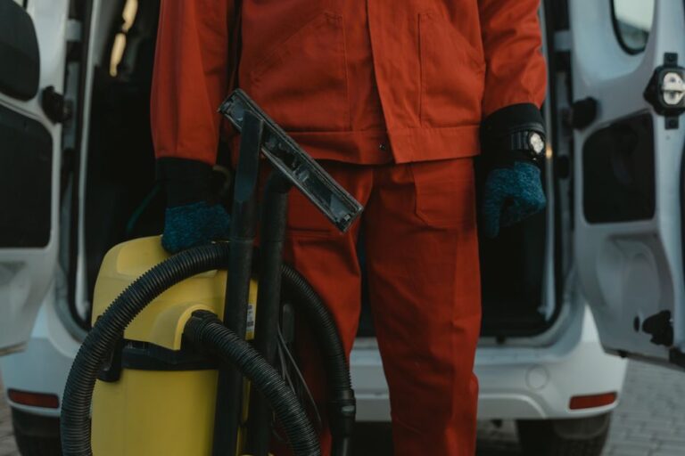 Restoration technician standing beside a service van, ready to respond to a water damage call