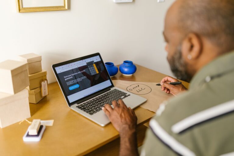 Small business owner researching marketing options on laptop