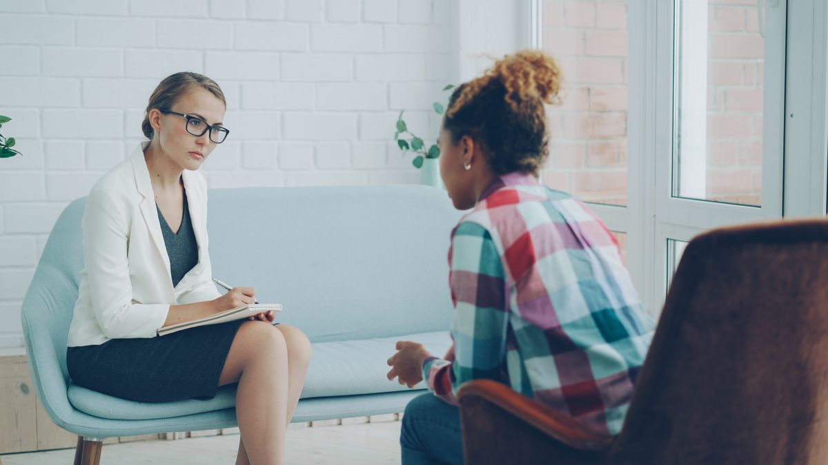 therapist and client in a bright, professional counseling office setting