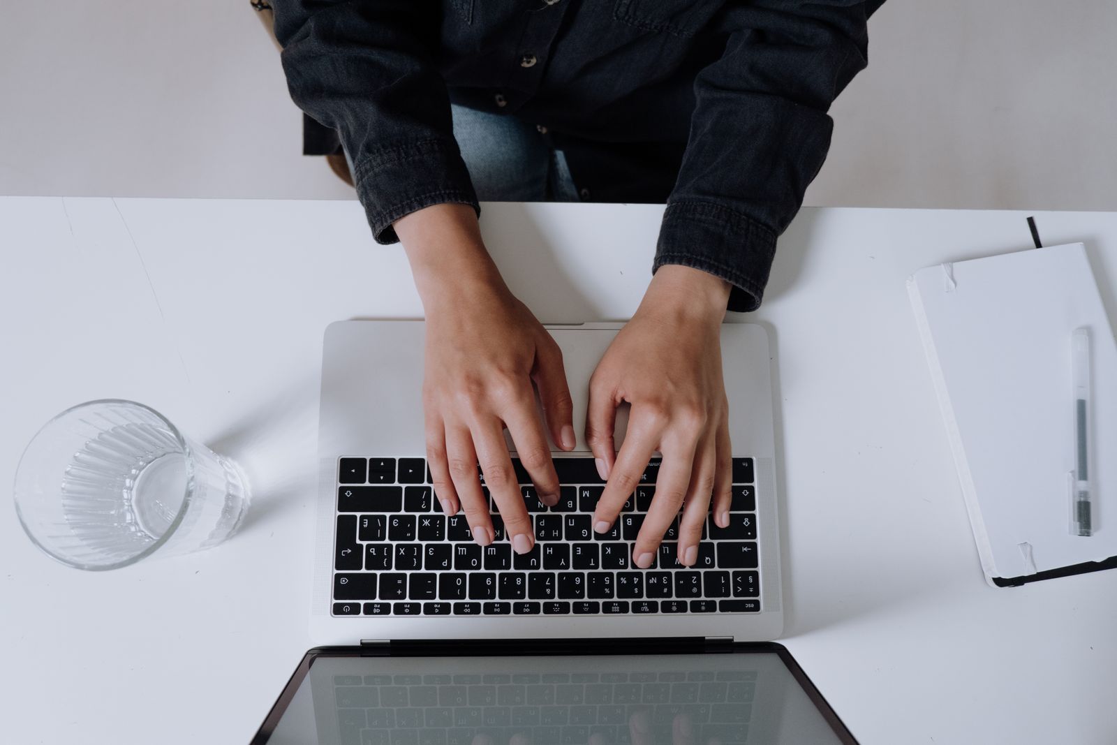 Person typing a long-form pillar page article on a laptop