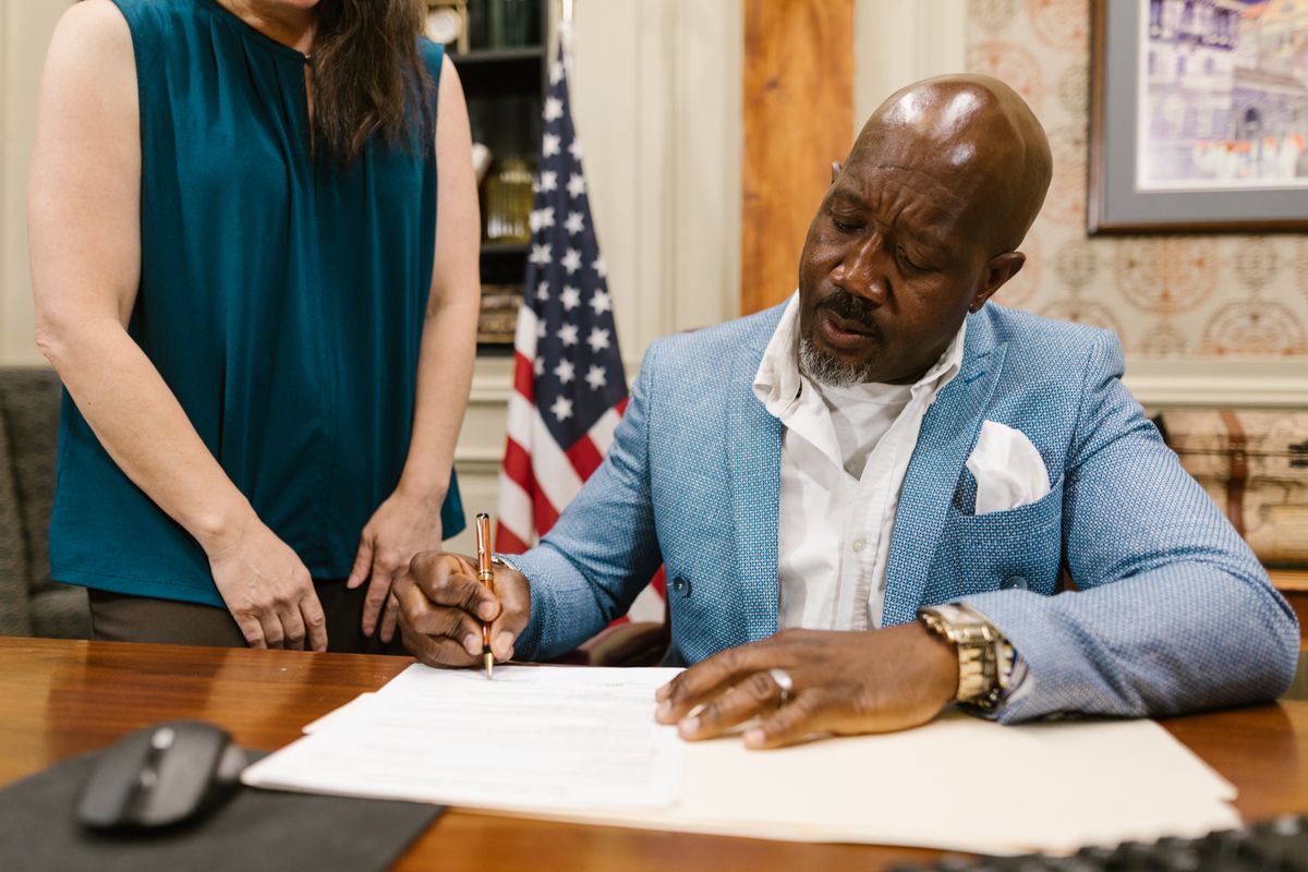 Client signing legal documents with attorney — estate planning leads often start with a Google search weeks before the first appointment