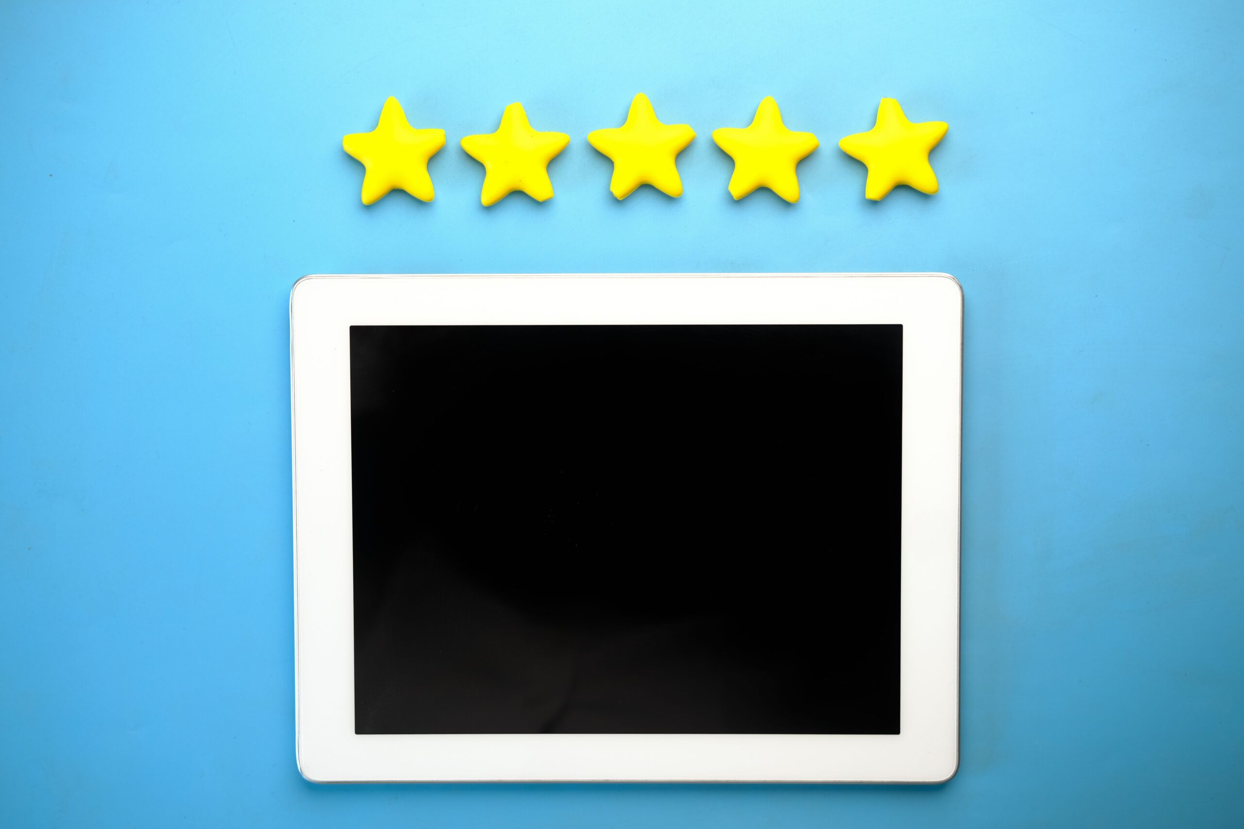 Five gold stars above a tablet representing positive customer reviews