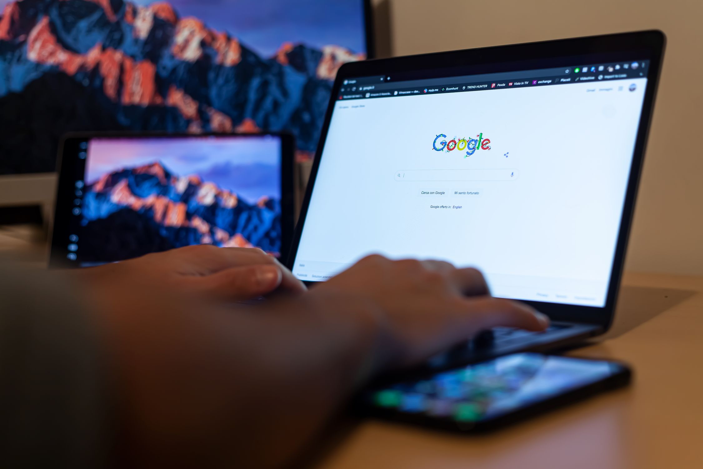 Hands typing on laptop with Google on screen, optimizing a Google Business Profile for local SEO