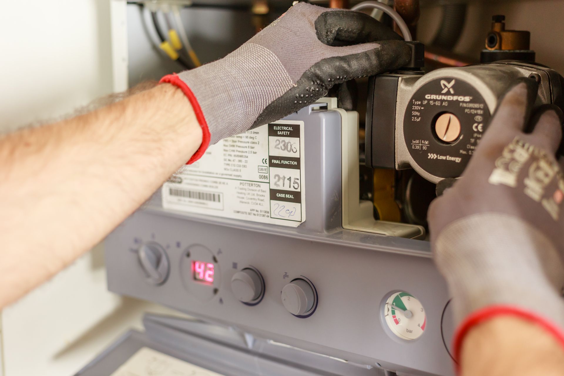 HVAC technician servicing a heating unit during a residential service call