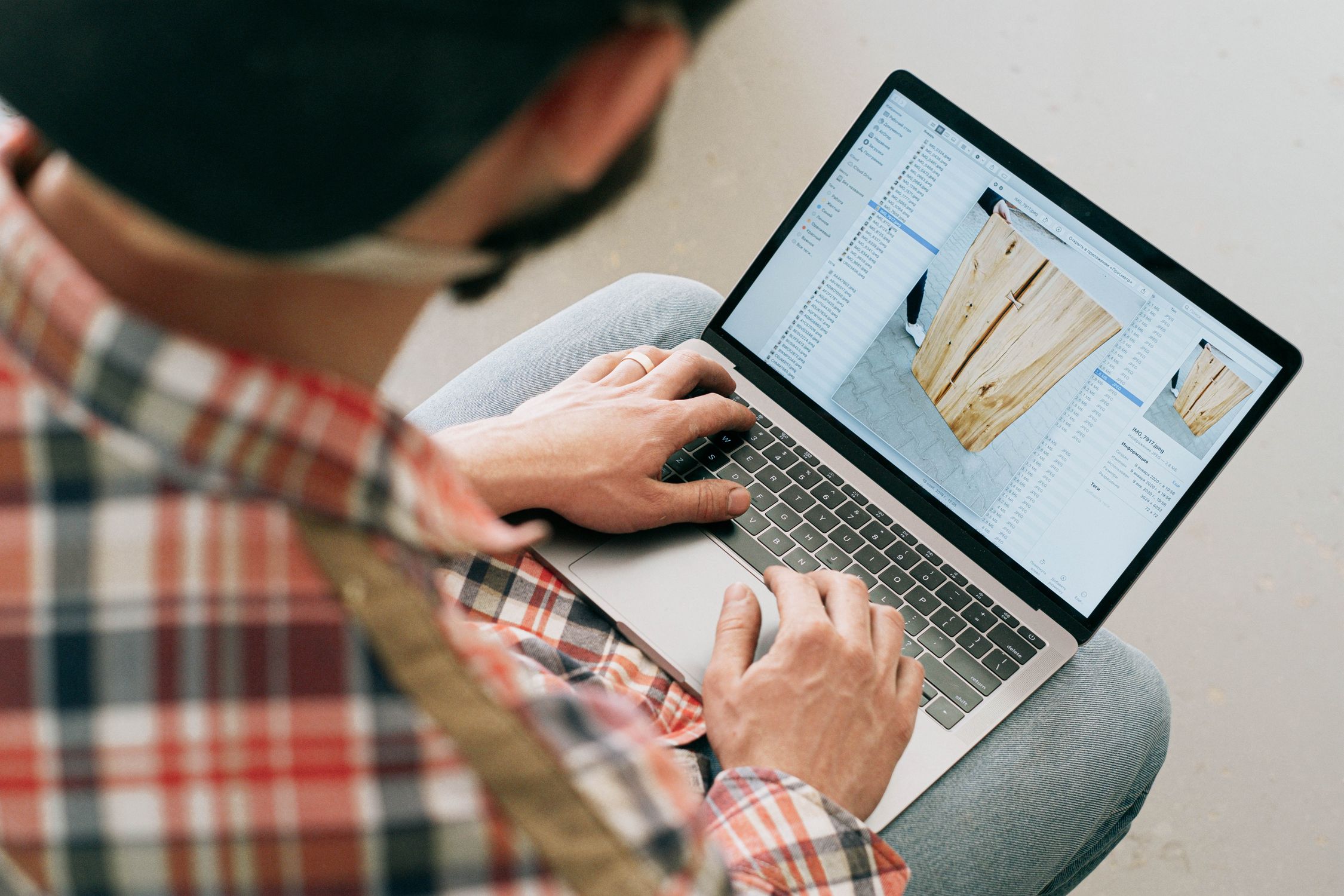 Craftsman using laptop in workshop to create SEO content that supports their Google Business Profile ranking