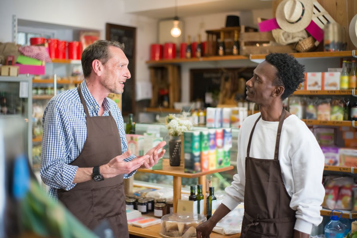 Two local business owners having a conversation inside their shop