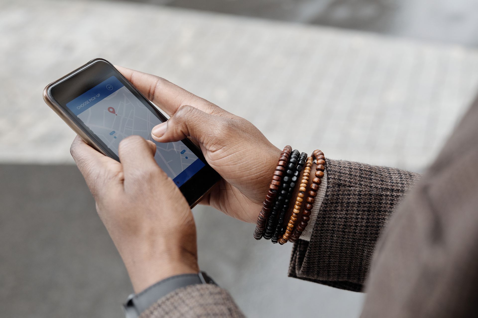 Person holding a smartphone displaying a local map search result