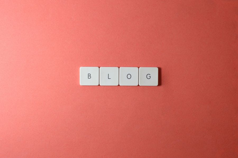 Blog content tiles on coral background representing content formatting strategy for featured snippets