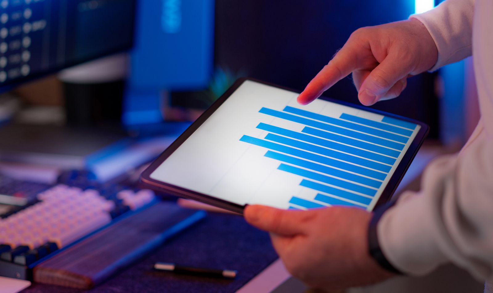 Business owner analyzing SEO performance data on tablet with bar chart