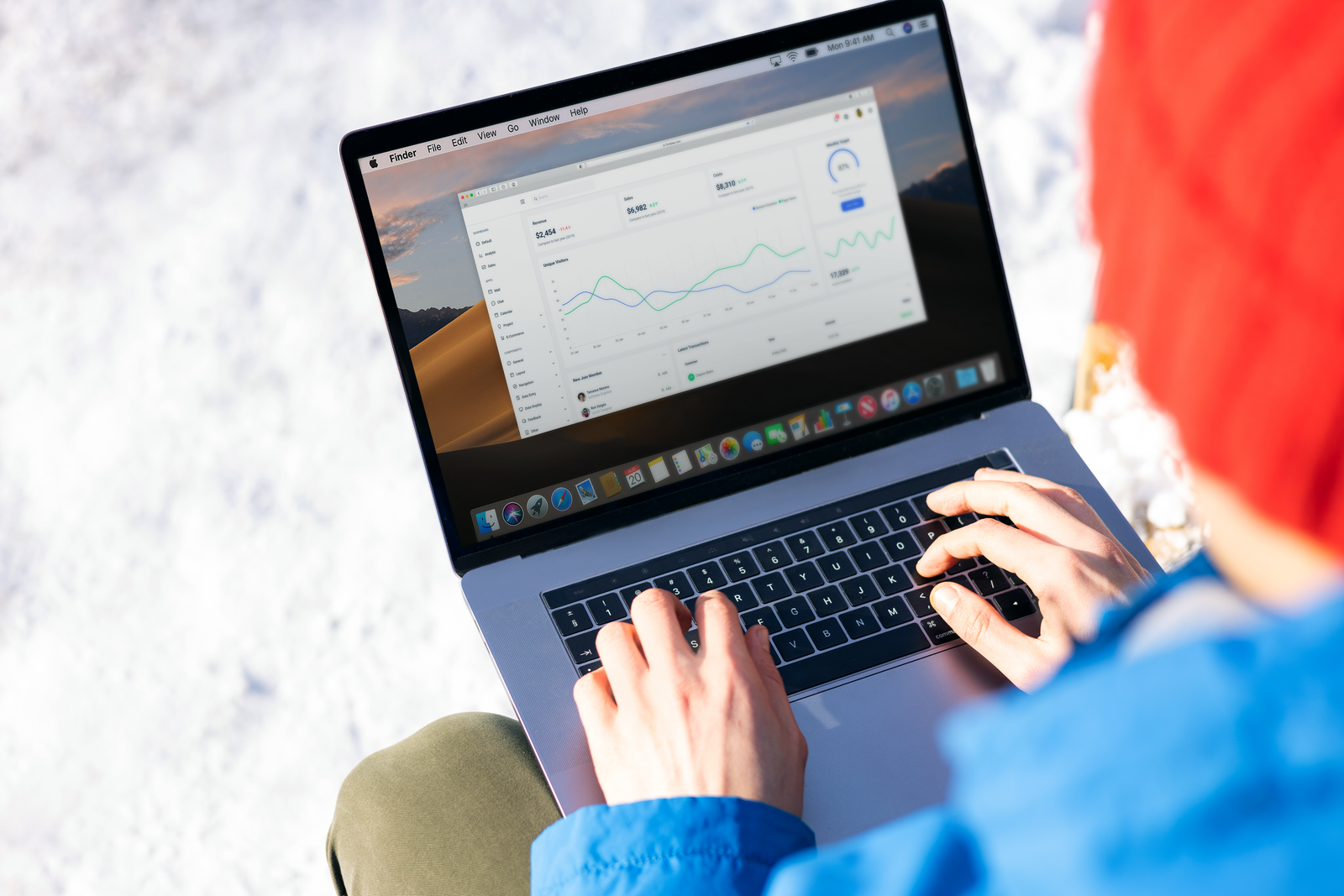 Person tracking SEO performance and website analytics on laptop using Google Analytics