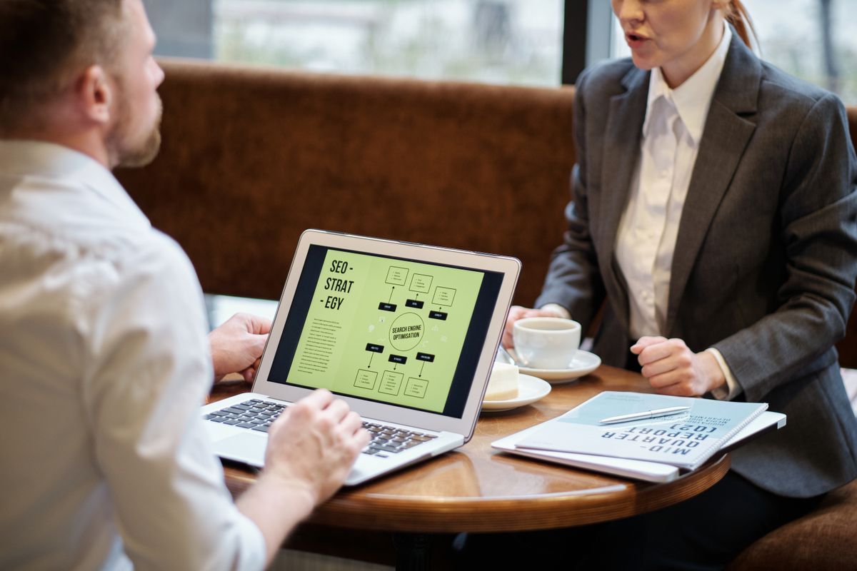 Business professionals reviewing an SEO strategy on a laptop screen