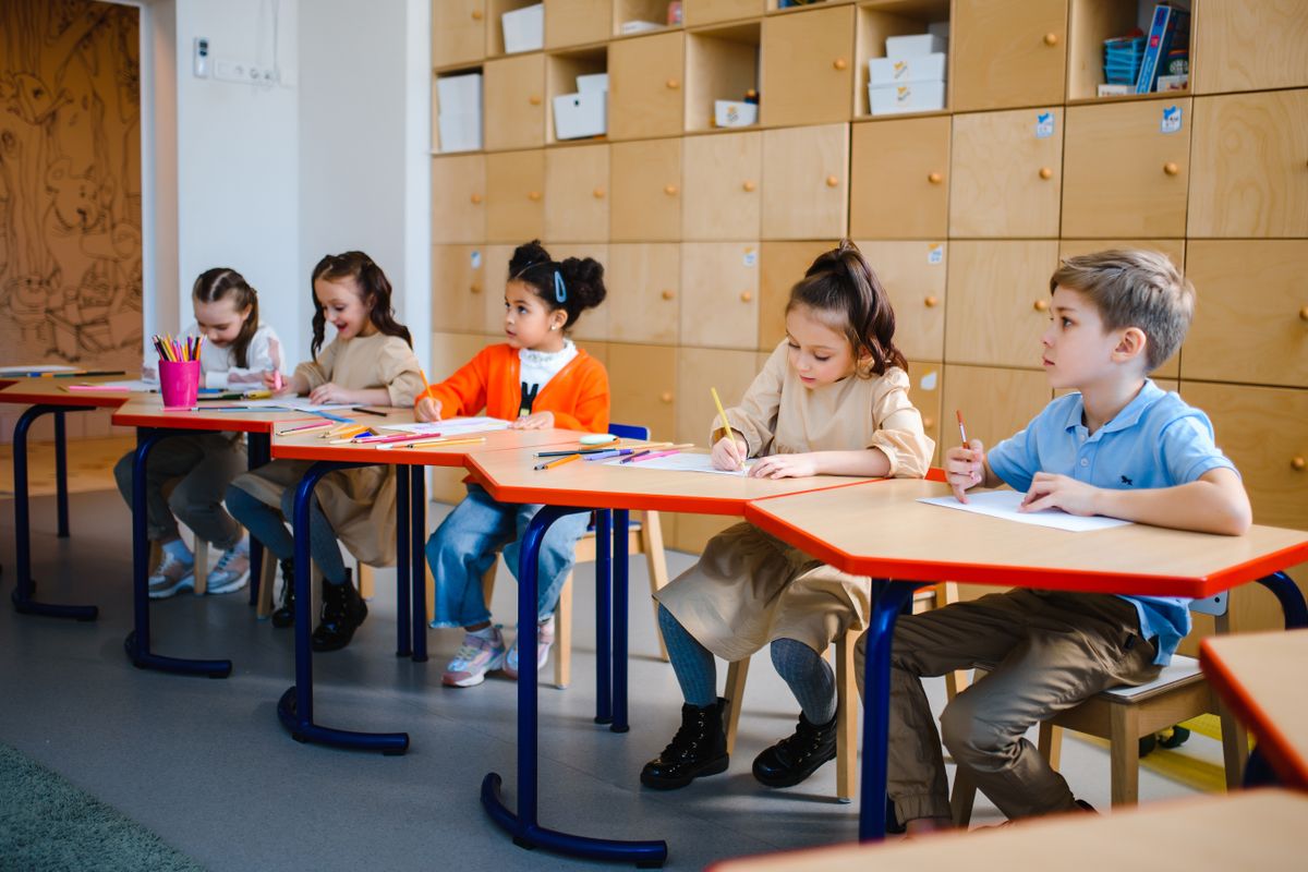 Preschool-aged children engaged in a structured activity in a daycare classroom