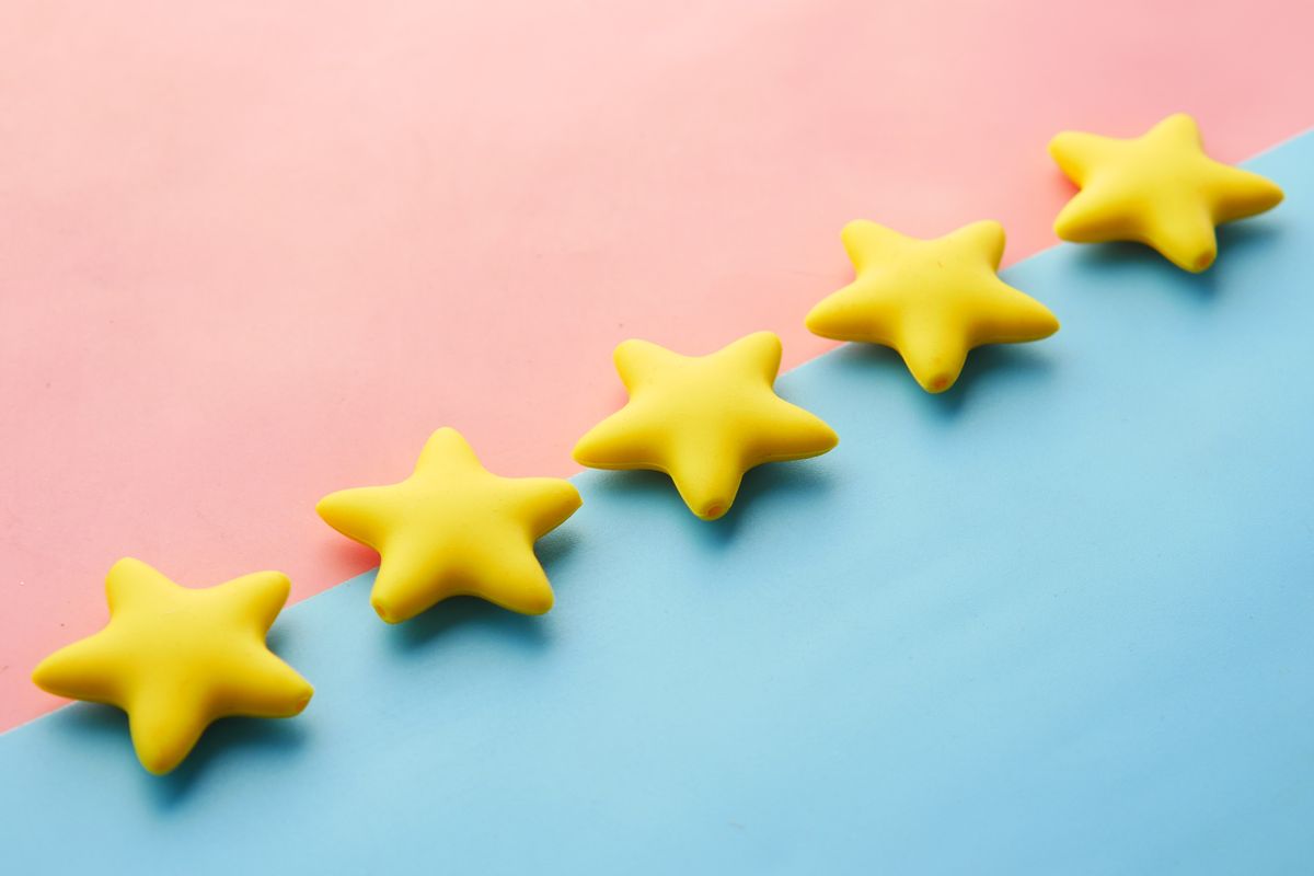 Parent leaving a five-star review for their child's daycare on a smartphone