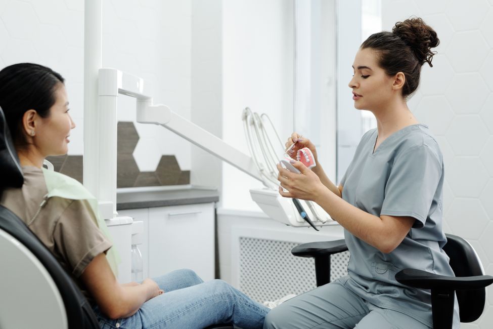 Dentist explaining a procedure to a patient during a consultation
