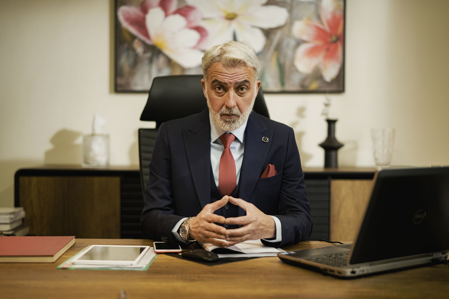 Funeral home owner reviewing his business website at his desk