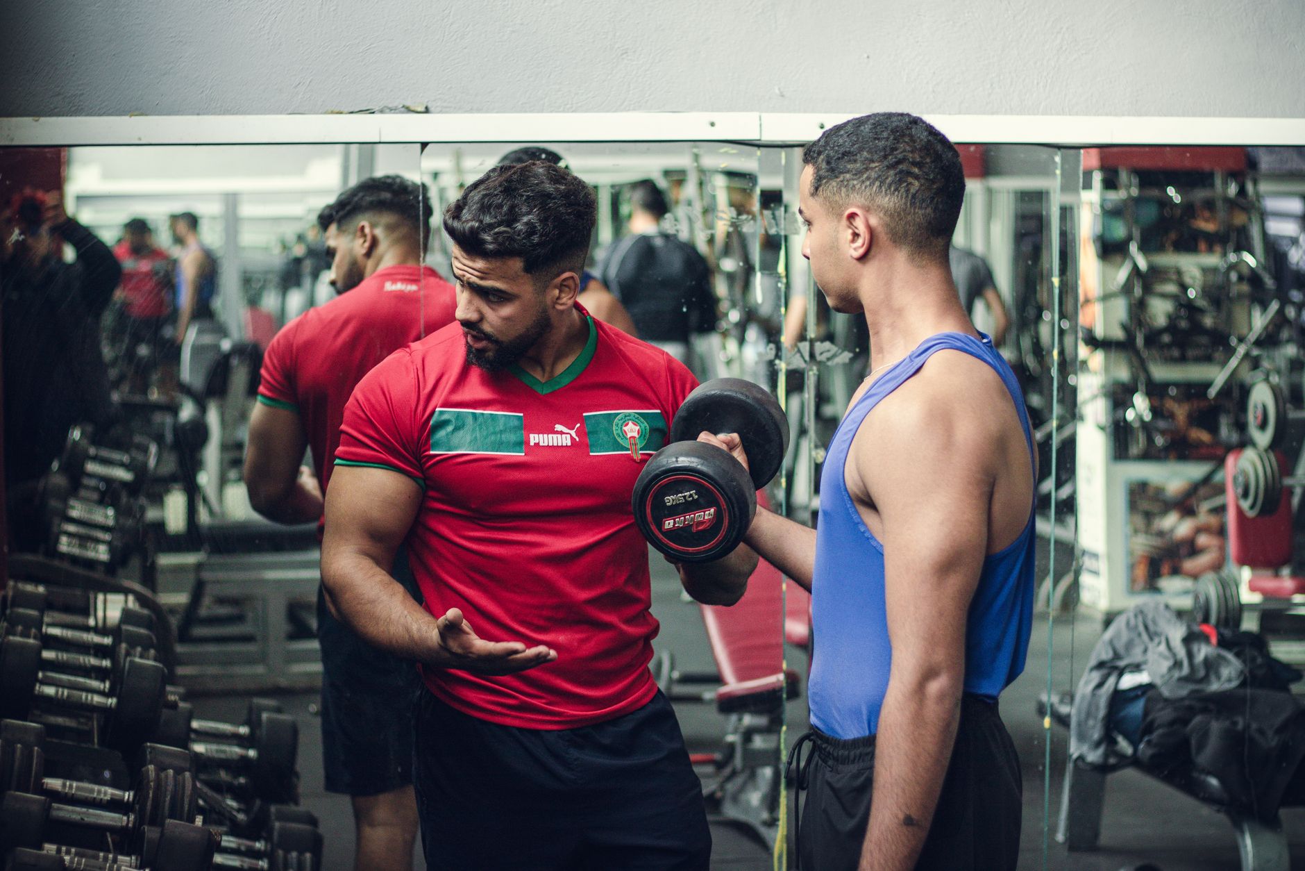 Fitness trainer assisting client during a strength workout