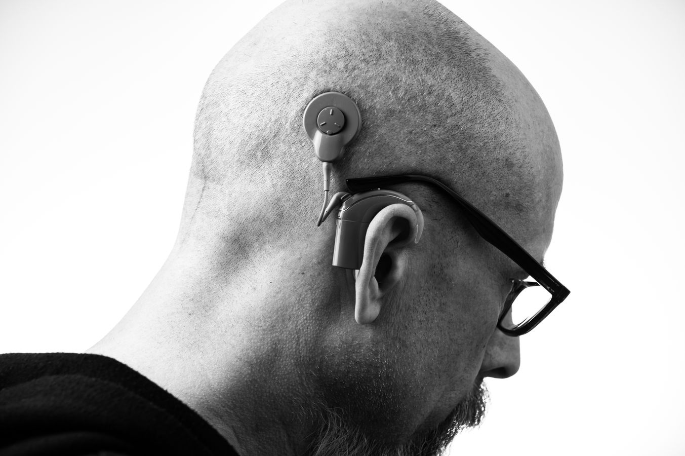 Profile portrait of a man wearing a hearing aid