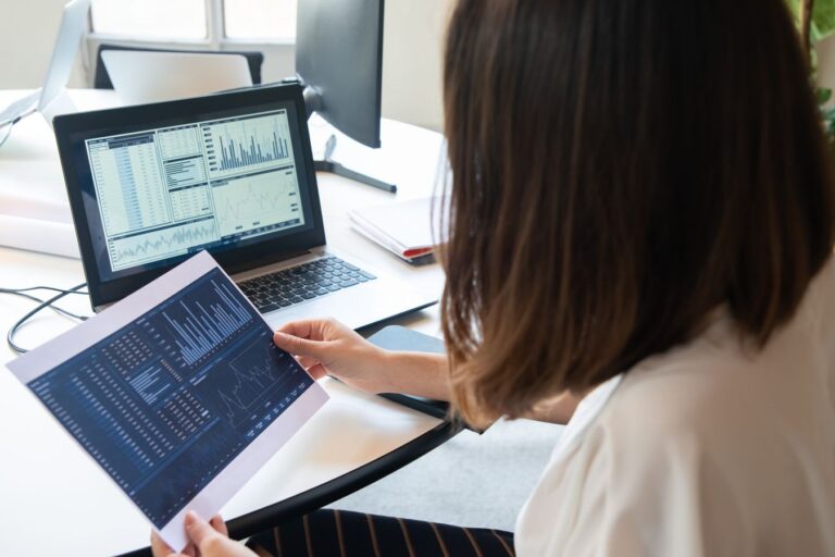 Small business owner reviewing a Google Ads and SEO performance dashboard on a laptop
