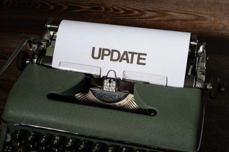 A close-up of a classic typewriter with a sheet displaying 'UPDATE' text, evoking nostalgia.