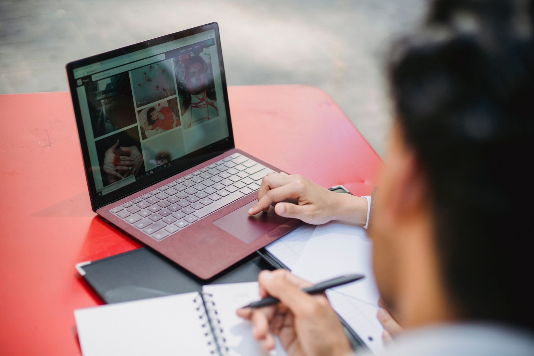 Business owner writing a pillar page article on a laptop for a local business website