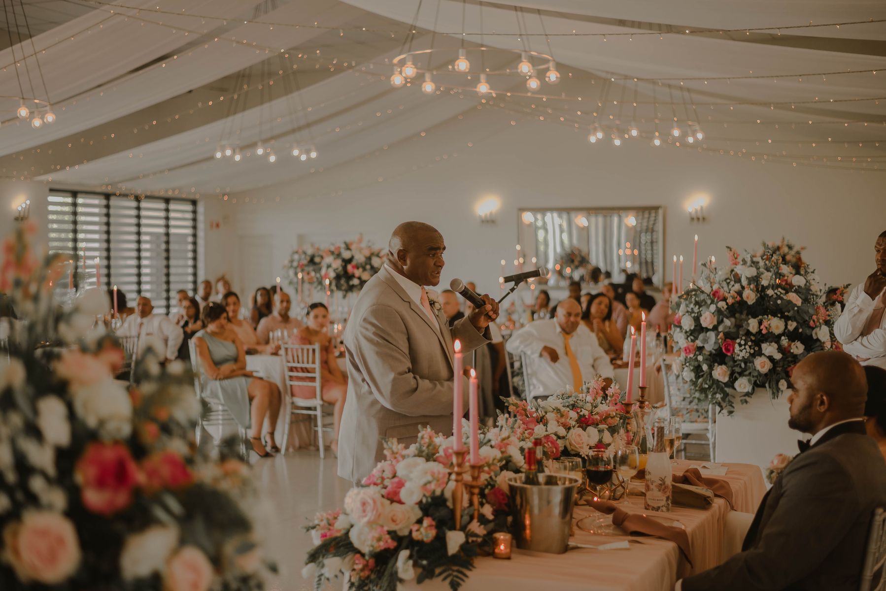 Outdoor wedding venue with rows of seating and a floral arch
