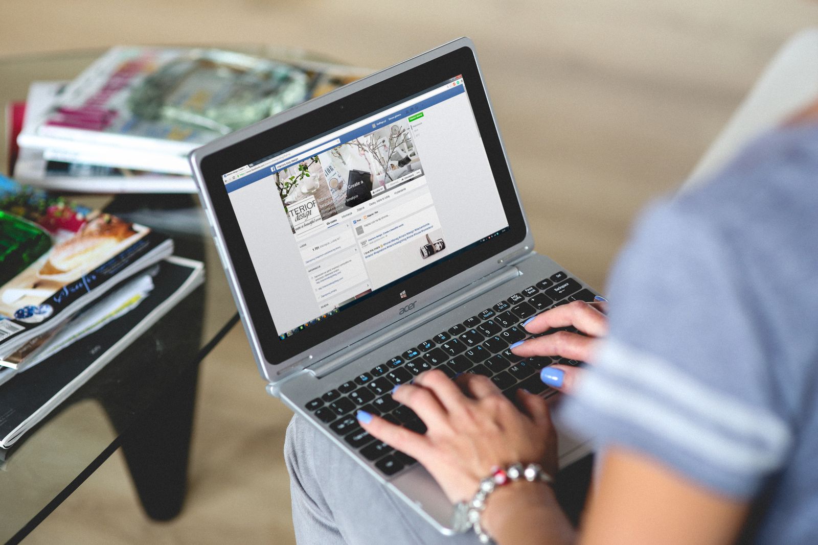 Small business owner typing notes while reviewing content on a laptop