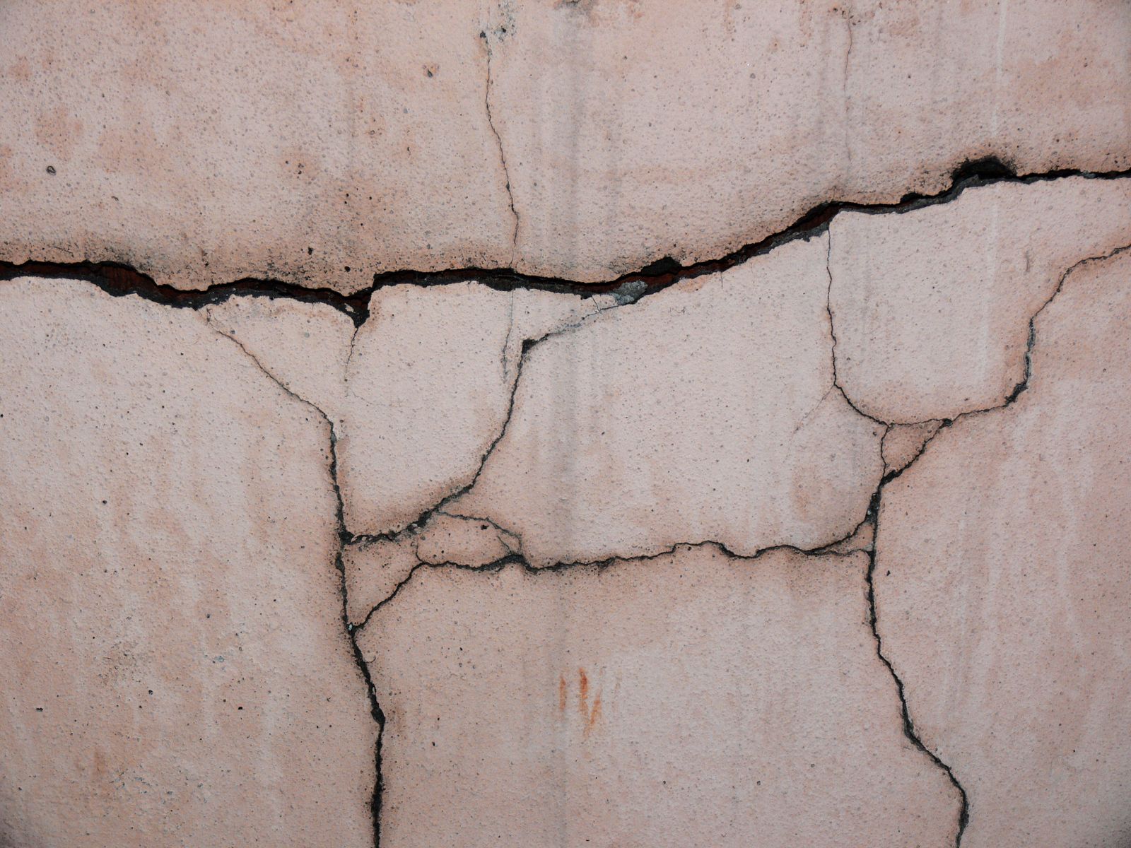 Close-up of a cracked concrete foundation wall showing the kind of structural damage homeowners search Google to understand