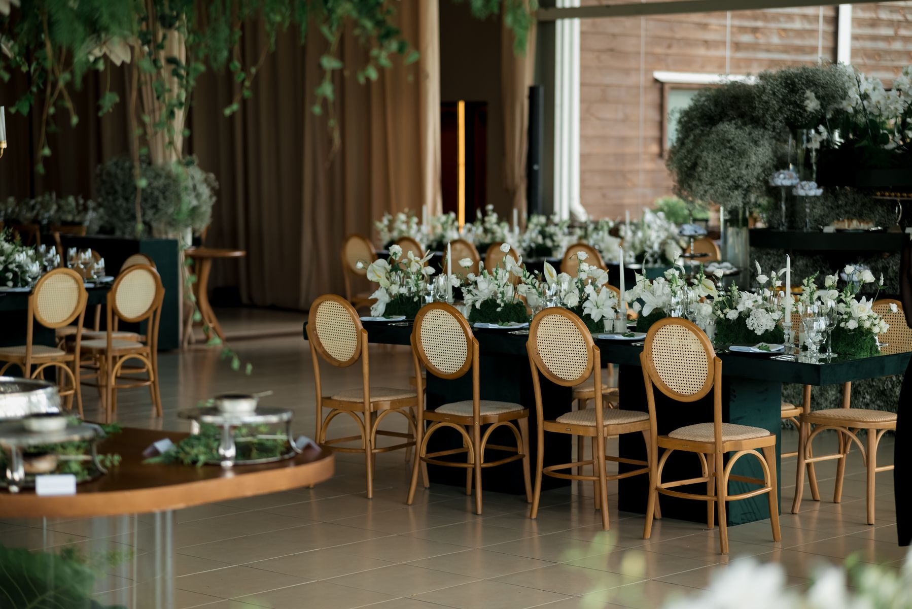 Empty event reception hall set up with round tables before a wedding
