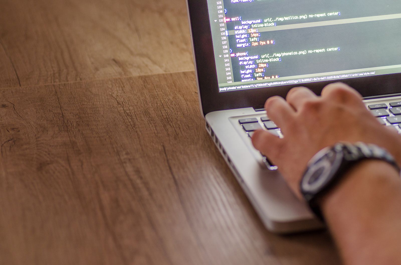 Developer reviewing website loading speed and performance on a laptop