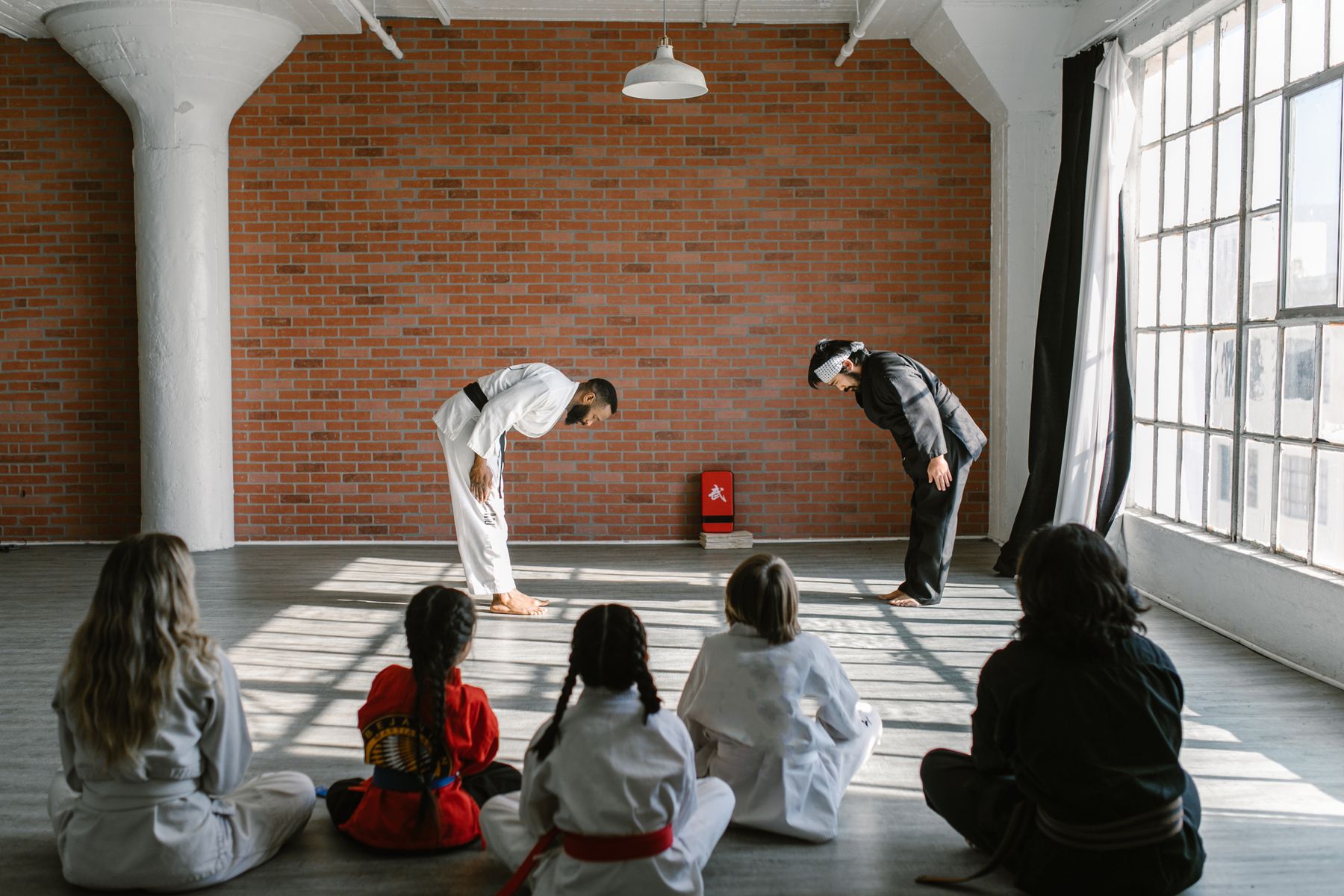 Instructor leading a taekwondo class in a dojo