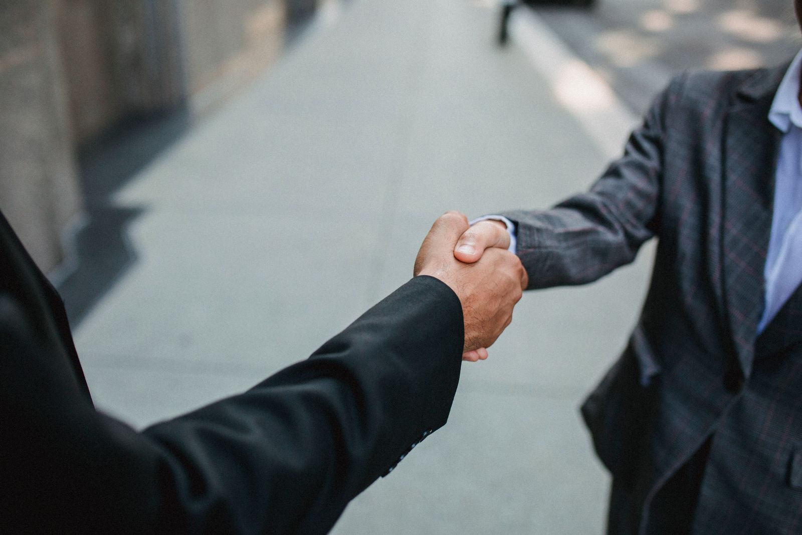 Two business owners shaking hands after a local partnership agreement