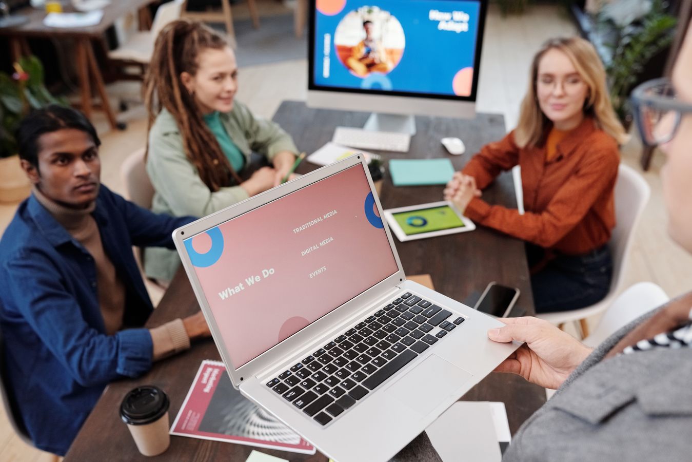 team reviewing website performance metrics on a laptop during an office meeting
