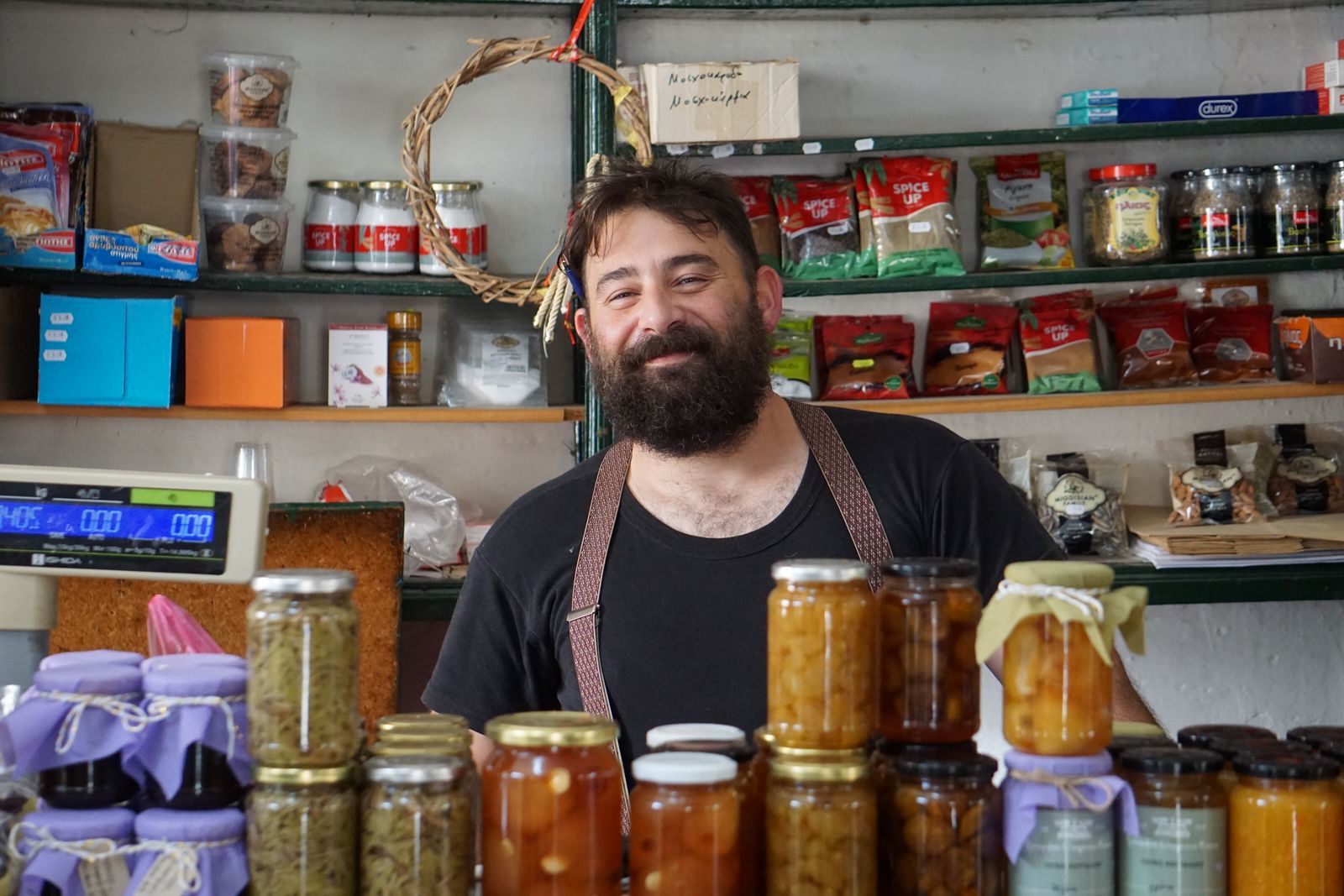 Small business storefront owner standing outside their shop