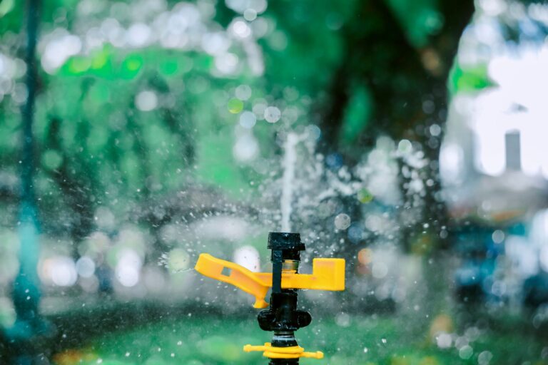 Irrigation technician installing a residential sprinkler system in a green lawn