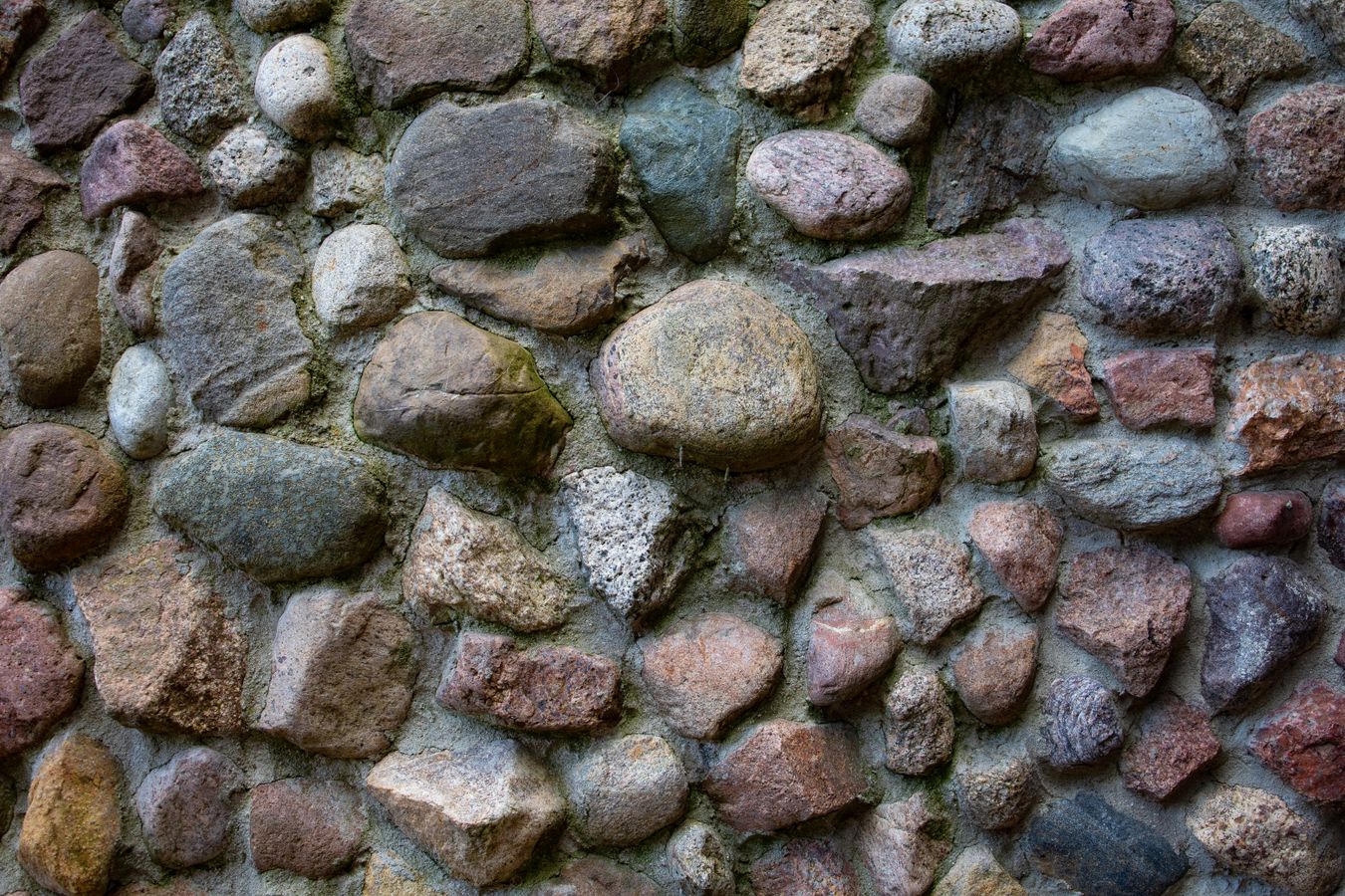 Finished stone retaining wall along a residential landscape