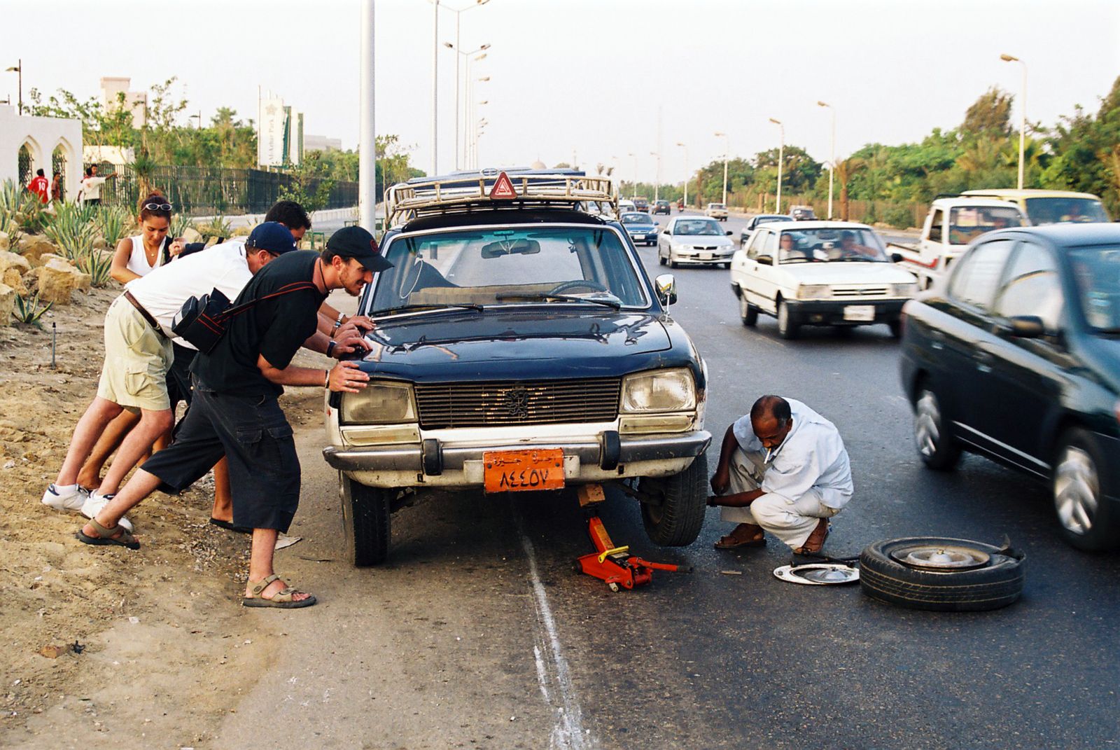 Roadside assistance team helping a driver with a car on the shoulder