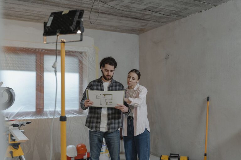 Interior designer reviewing renovation plans with fabric swatches in a bright modern studio