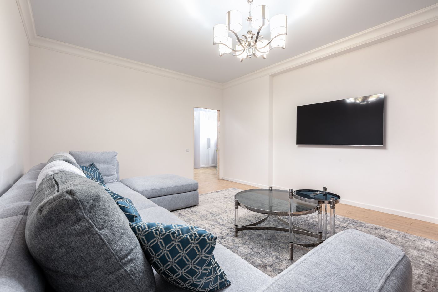 Finished modern living room with warm wood tones and minimal decor