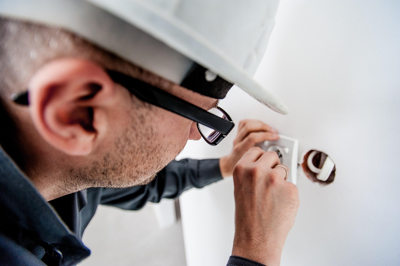 professional electrician at work on electrical system