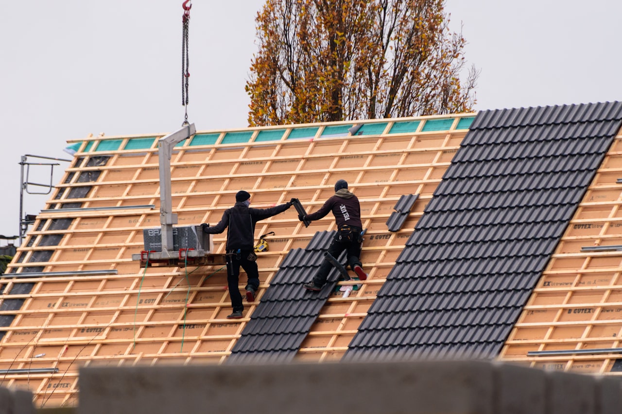 workers installing roof tiles on new residential construction