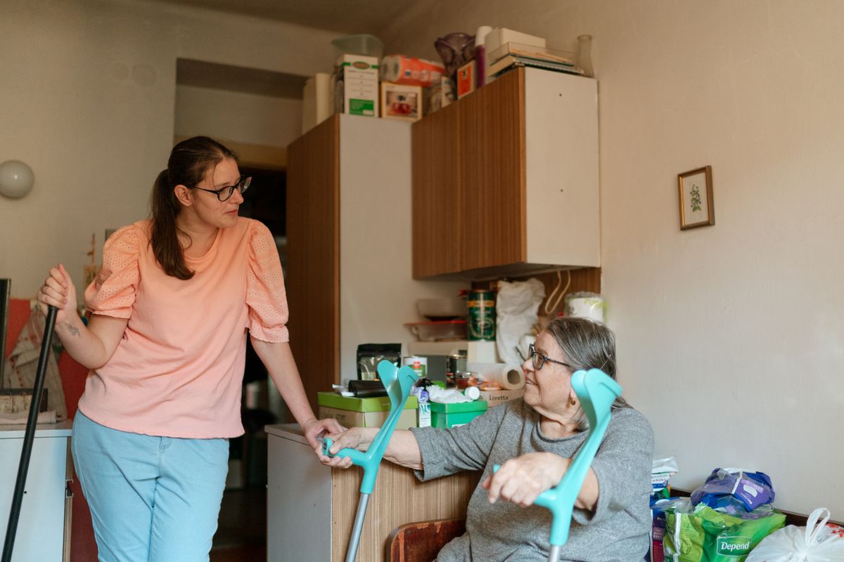 Caregiver assisting senior client outdoors, representing quality in-home care services