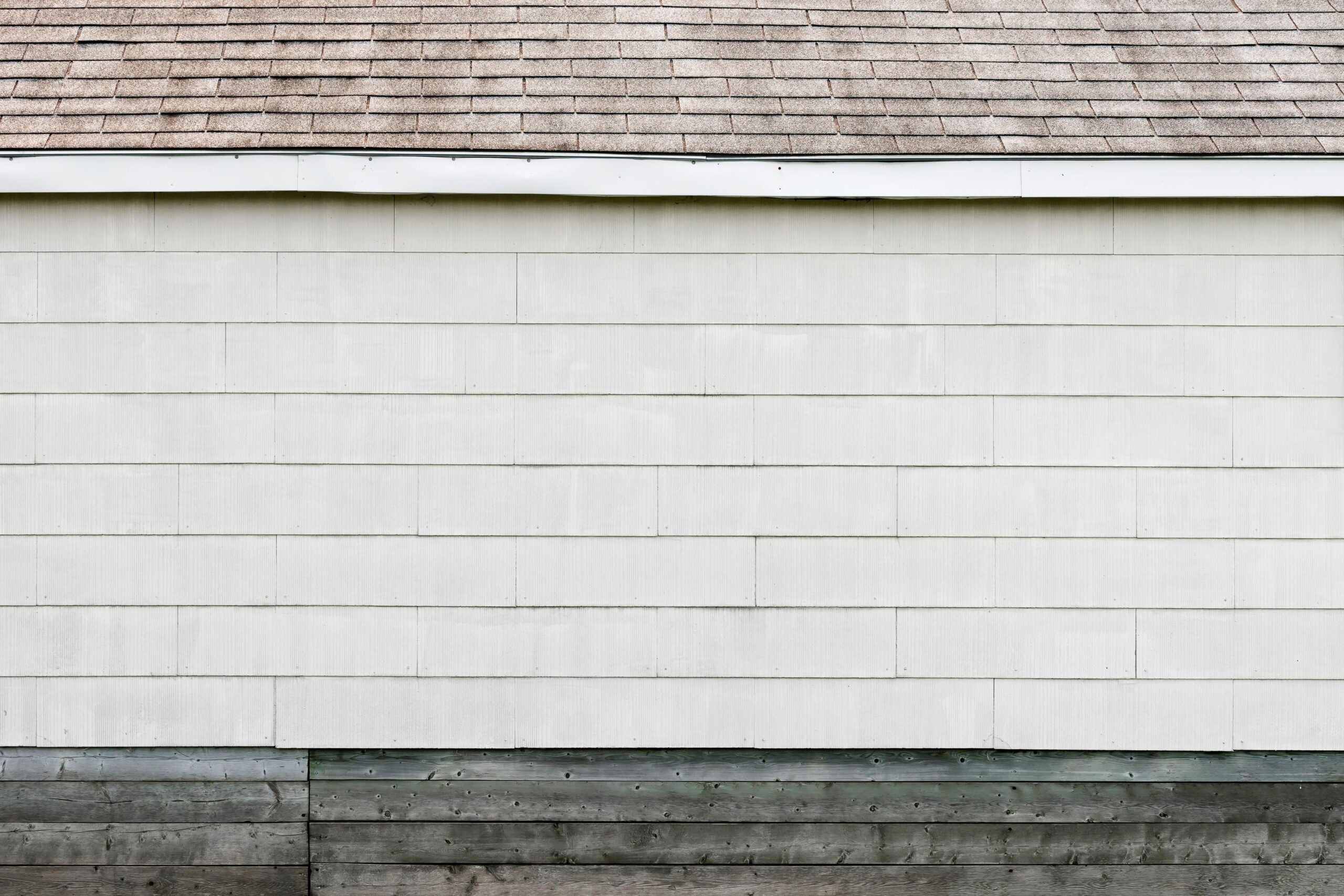 Finished white siding on a home exterior wall with clean lines
